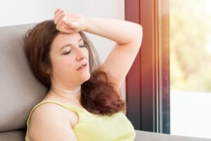 woman feeling warm and exhausted due to air conditioner breakdown