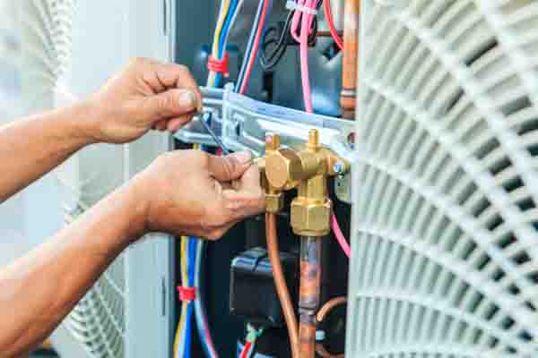 hvac technician preparing to install air conditioner