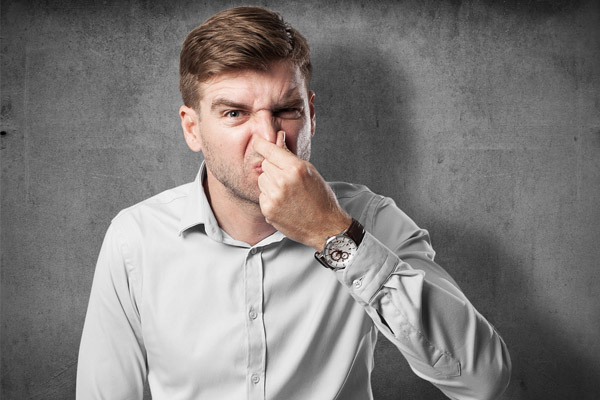 man who smells heating oil in his home