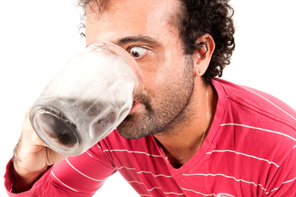 man drinking cold water since air conditioner is blowing warm air