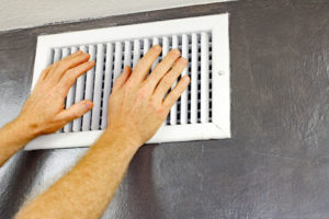 hands over air conditioner vents