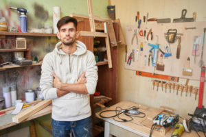 image of a man working in garage with no air conditioning