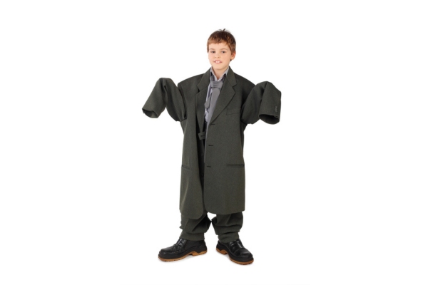 little boy wearing oversized suit and boots depicting oversized air conditioner