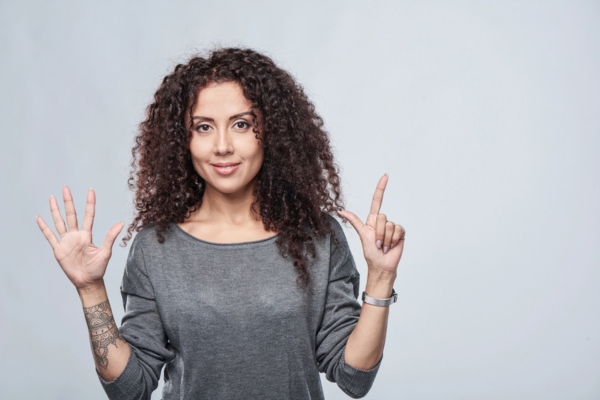 woman holding 7 fingers up depicting 7 Reasons Your HVAC Filter Isn’t Fixing Your Indoor Air Quality
