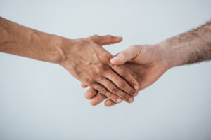 hvac contractor shaking hands with homeowner