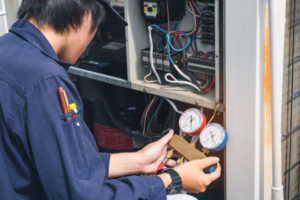 image of an hvac contractor performing an air conditioner installation