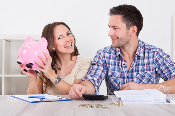 image of a happy couple saving money after air conditioner maintenance