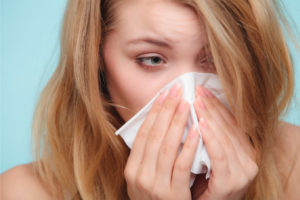 image of a homeowner experiencing allergies