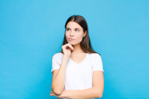 image of a thinking young woman depicting replacing only just the outside AC unit