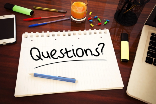 questions written on a notebook depicting FAQs about air conditioner not turning on