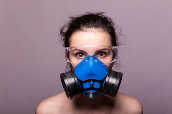 woman wearing gas mask depicting gas odor from air conditioner