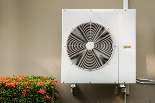 air conditioner compressor installed outside the house