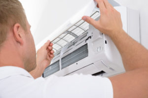 image of an hvac contractor performing ductless mini split tune-up