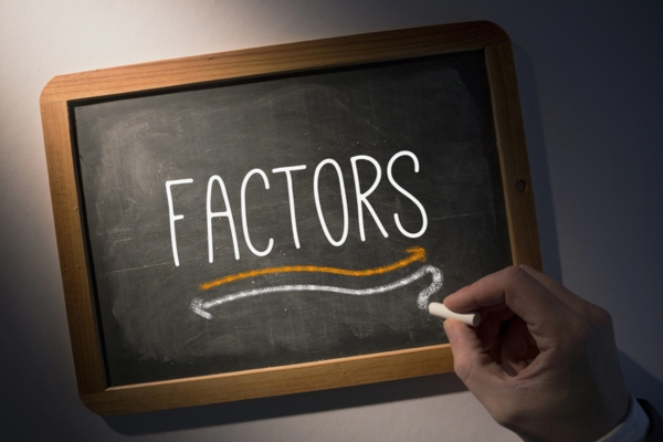 Factors written on a chalkboard depicting Standby Power Generators installation