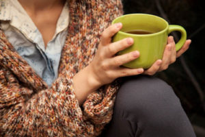 homeowner drinking hot tea during power outage in winter