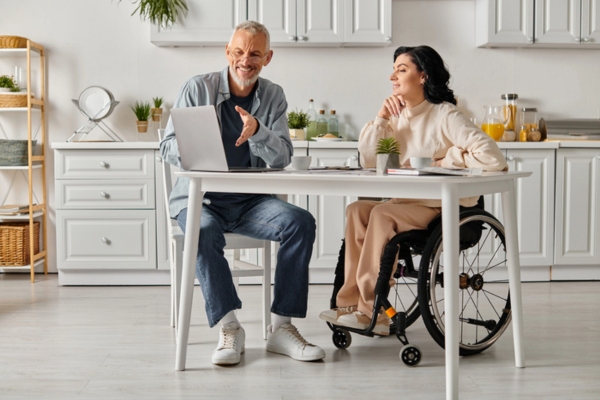 couple sitting on the kitchen table while evaluating oil tank size needed for the house