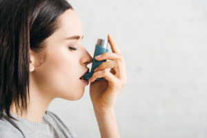image of girl with inhaler depicting indoor air pollution