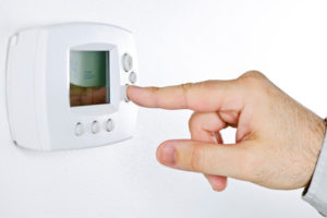 hand adjusting heat pump thermostat