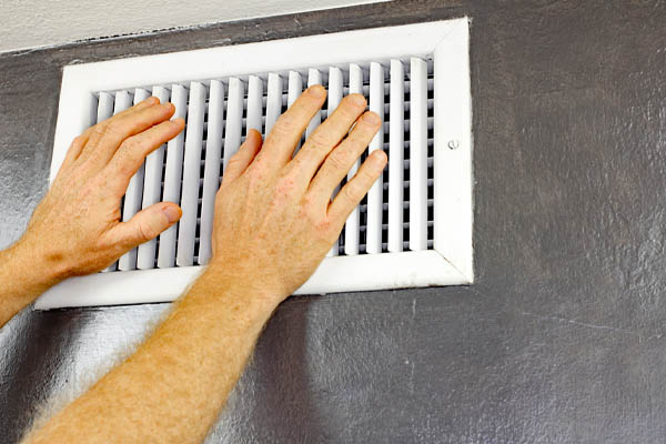 image of an air conditioner air vent depicting ac outdoor unit that is working but not cooling