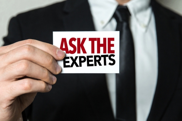 man holding card that says Ask The Experts depicting generator maintenance