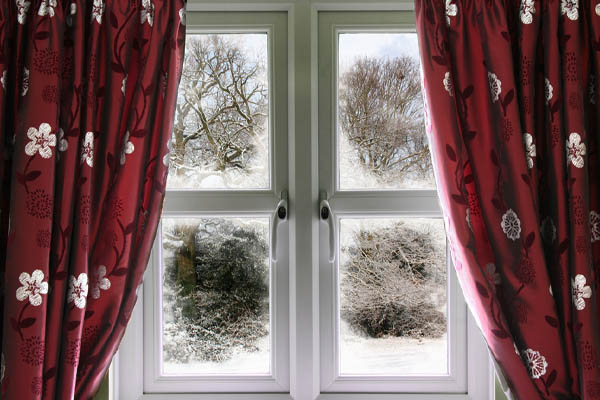 image of a window in winter depicting window air leaks