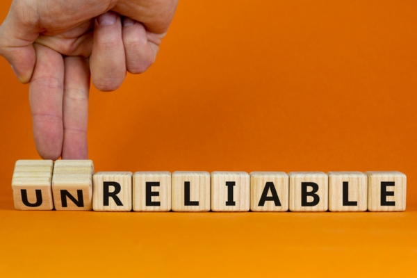 unreliable spelled using wooden letter dice depicting whole house generator