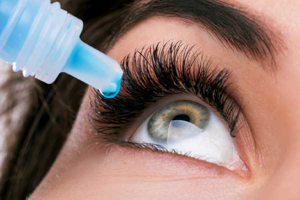 image of homeowner putting artificial tears in eyes depicting poor air quality in winter