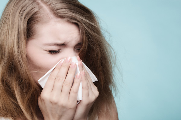image of a homeowner suffering from allergies due to poor indoor air quality