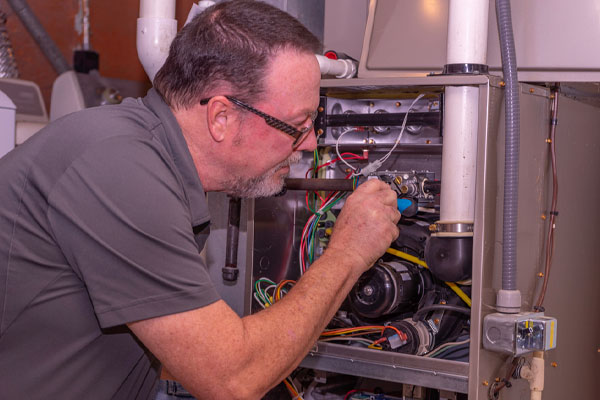 image of an hvac contractor repairing a furnace that won't turn off