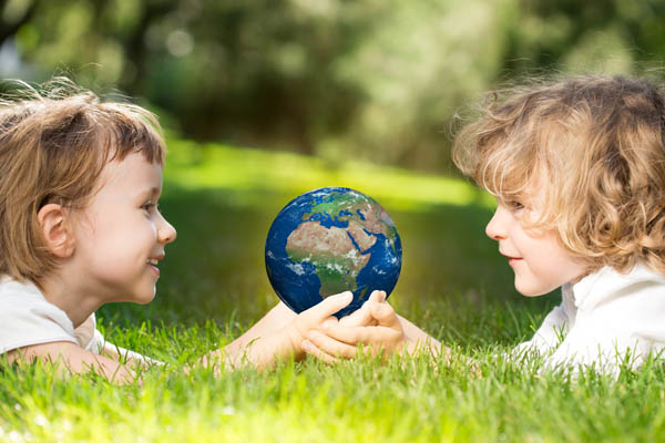 image of children holding earth depicting whole house generator