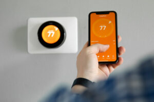 image of homeowner adjusting thermostat setting for an oil heating system