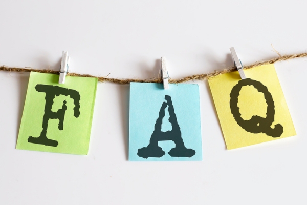 FAQ on colored paper clipped on a thin rope depicting questions about AC installation