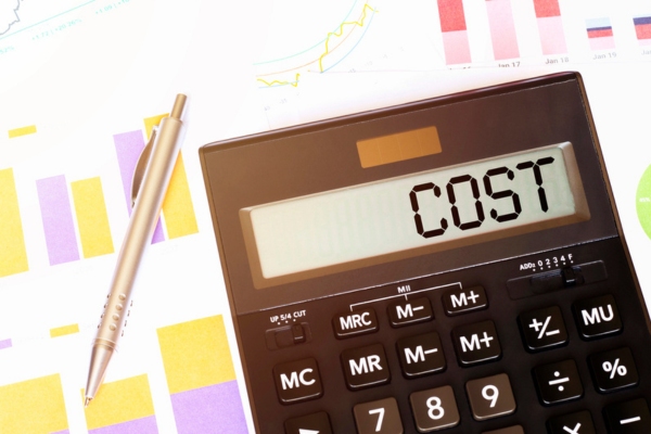 cost spelled on a calculator beside a pen depicting AC installation