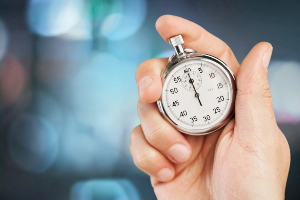 stopwatch in a man's hand depicting air conditioner installation time