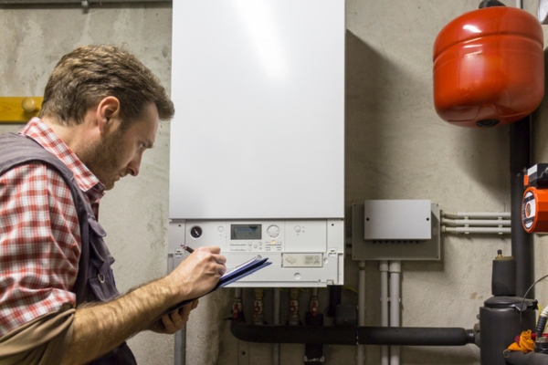 HVAC technician evaluating boiler