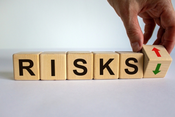 RISKS spelled using wooden letter cube depicting Skipping Furnace Filters