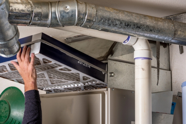 image of a homeowner installing furnace filter
