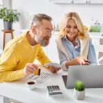 couple budgeting expenses including heating oil delivery