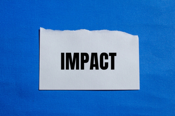 impact word written on a torn white paper