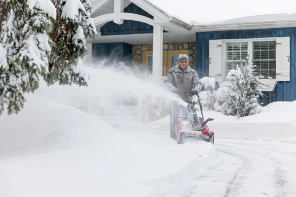 man using snowblower at home