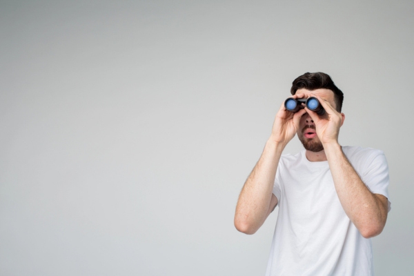 man looking through binoculars depicting What To Look For In An HVAC Contractor