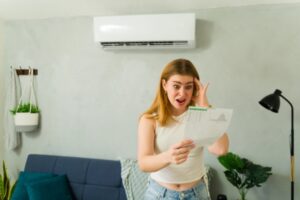 woman looking stressed while reading energy bill