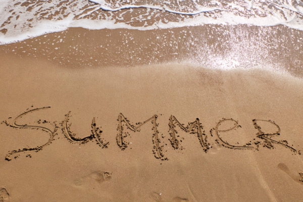 Summer word written on the shore