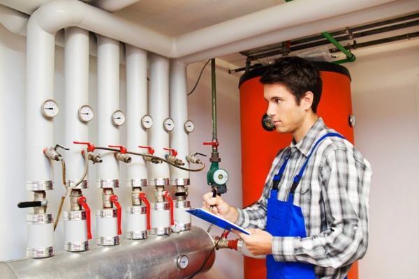 HVAC technician performing checks in the boiler room