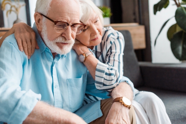 senior couple sitting on a couch