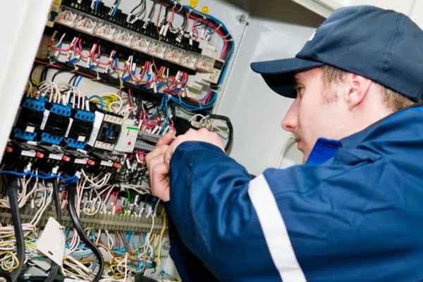 electrician making adjustments to accommodate air conditioner