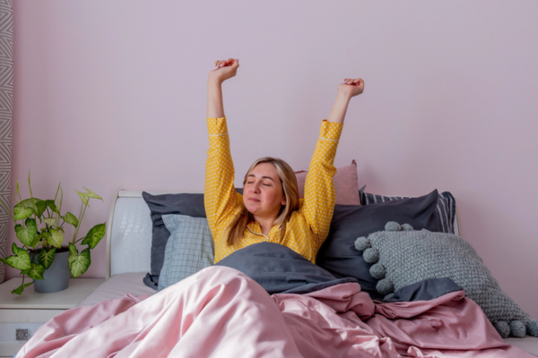 woman feeling refreshed after waking up due to modern air conditioner