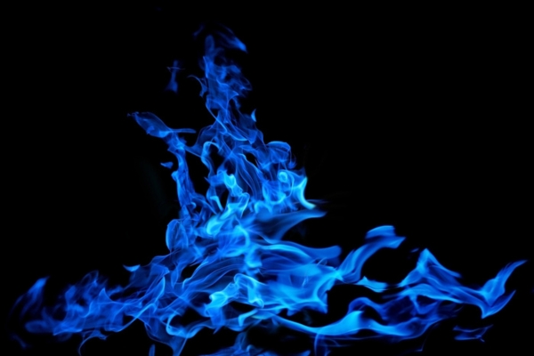 blue flame on black background depicting furnace flame