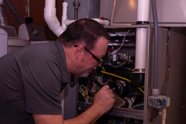 image of a furnace technician at work