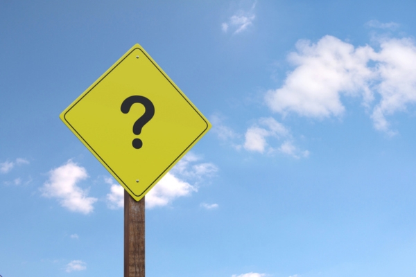 question mark on a yellow road sign depicting FAQs About Heating Oil vs Electric Heat